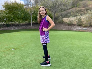 Daughter of Cionic founder Jeremiah Robison posing with Cionic Neural Sleeve